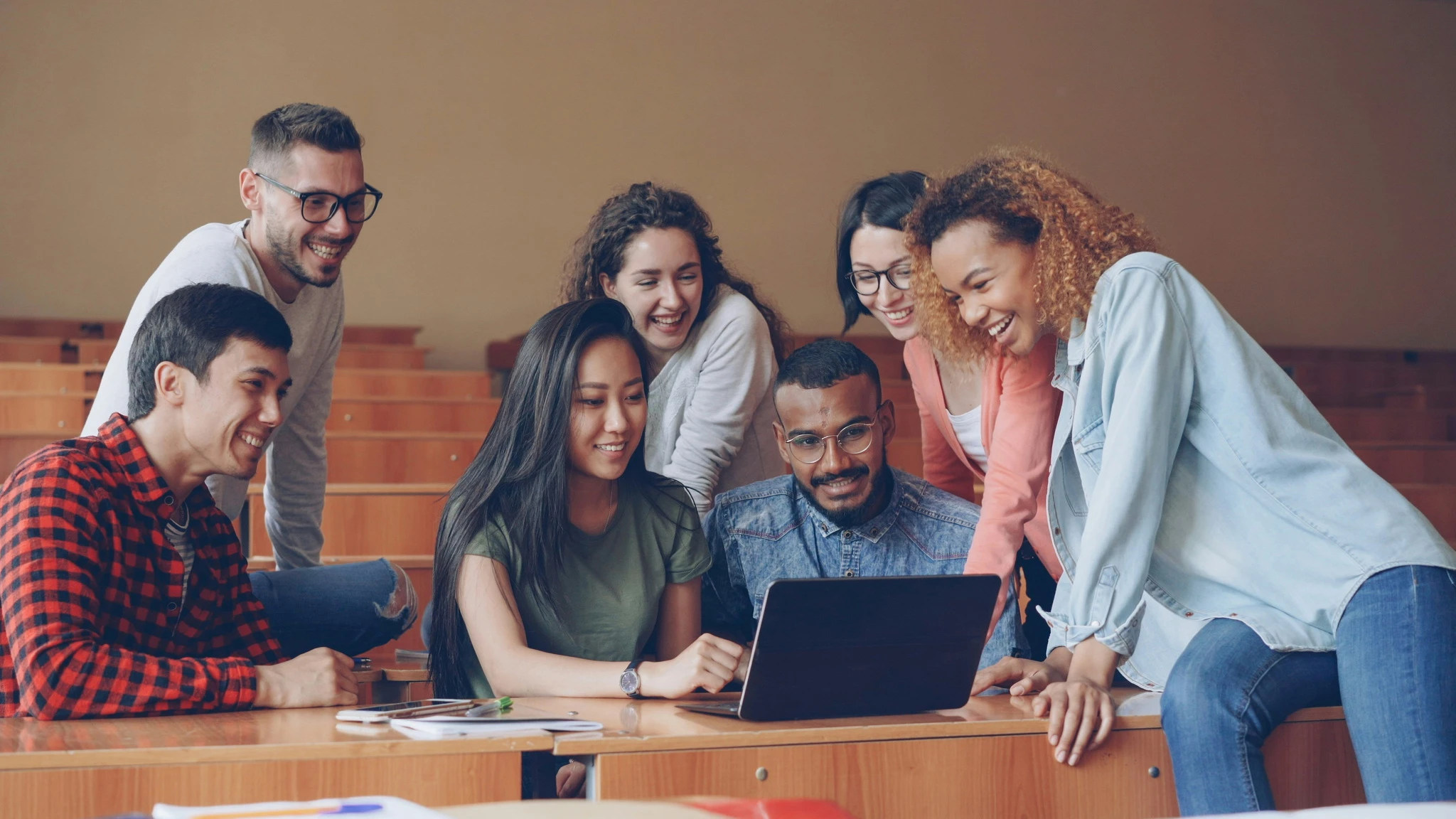 Educators gathered around a laptop